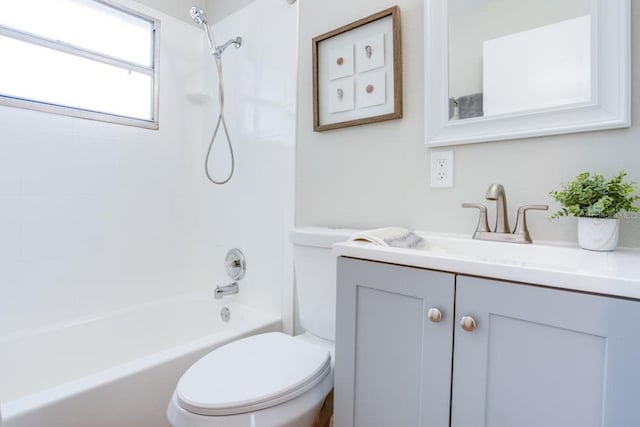 full bathroom with tiled shower / bath, vanity, and toilet