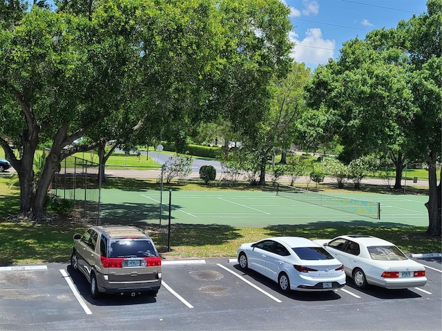 view of parking featuring tennis court