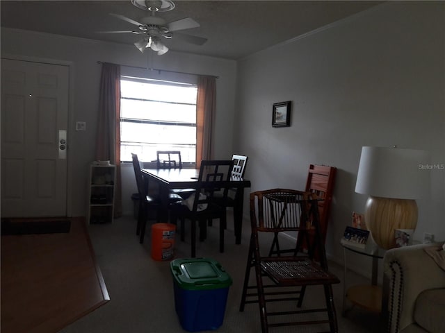 dining space with carpet and ceiling fan