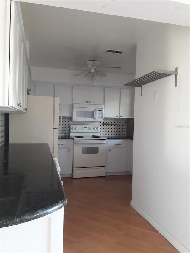 kitchen featuring hardwood / wood-style flooring, white appliances, decorative backsplash, white cabinetry, and ceiling fan