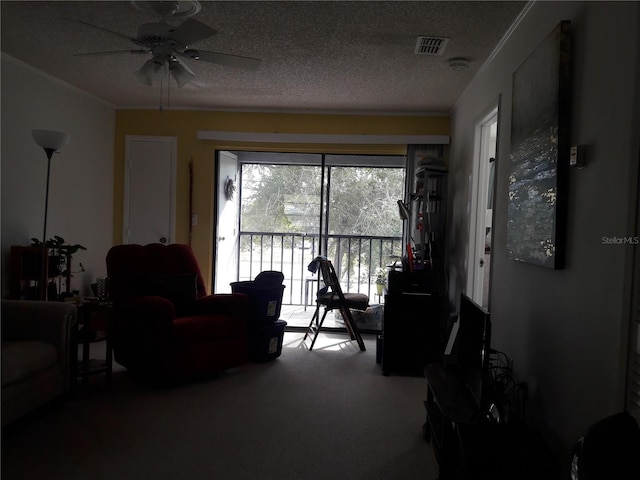 living room with carpet floors, a textured ceiling, and ceiling fan