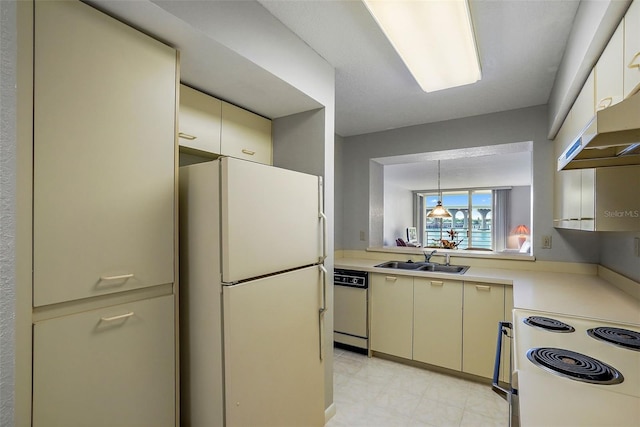 kitchen with light tile floors, pendant lighting, white appliances, and sink