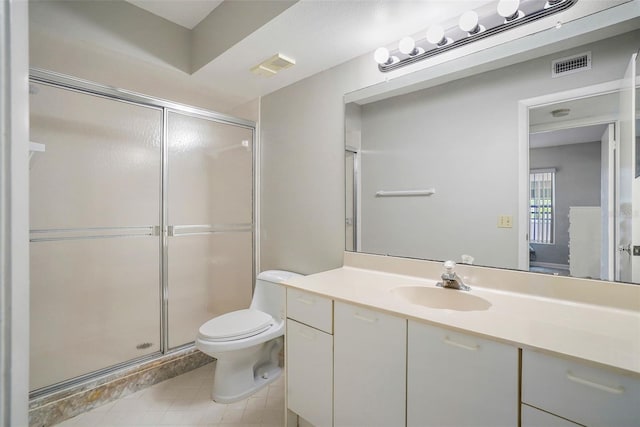 bathroom with a shower with shower door, vanity with extensive cabinet space, toilet, and tile flooring