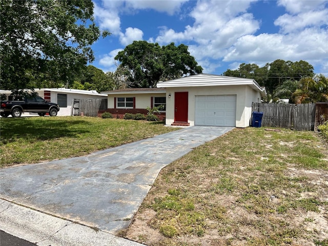 ranch-style home with a garage and a front lawn