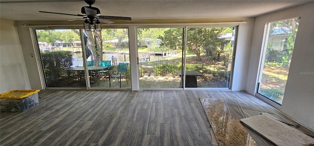 unfurnished sunroom with ceiling fan