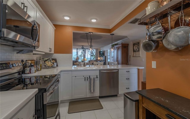 kitchen with light tile floors, white cabinets, sink, tasteful backsplash, and stainless steel appliances