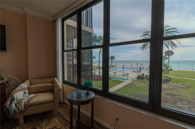 sunroom featuring a healthy amount of sunlight and a water view