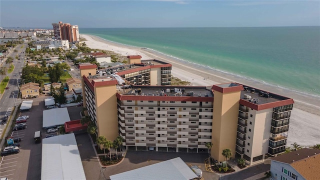 bird's eye view featuring a water view and a beach view