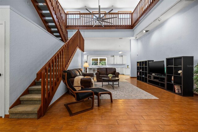 interior space with wood-type flooring and a high ceiling