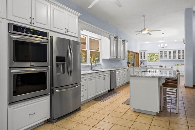 kitchen featuring white cabinets, sink, a healthy amount of sunlight, and stainless steel appliances