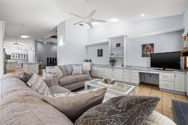 living room featuring high vaulted ceiling, built in desk, ceiling fan, and light tile floors