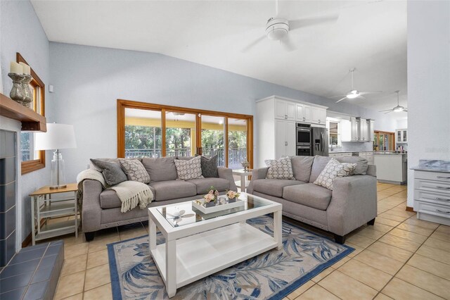 tiled living room with vaulted ceiling and ceiling fan