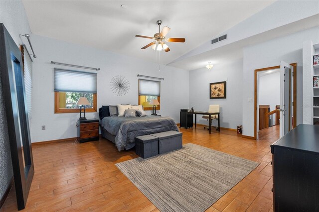 bedroom featuring light hardwood / wood-style floors, ceiling fan, and vaulted ceiling