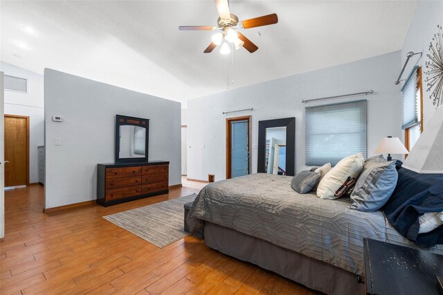 bedroom featuring light hardwood / wood-style floors, ceiling fan, and vaulted ceiling