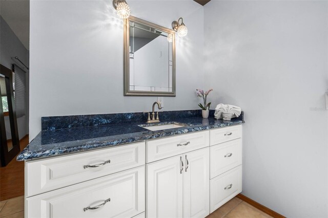 bathroom with vanity and tile flooring