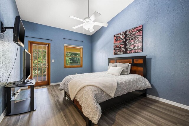 bedroom featuring ceiling fan, lofted ceiling, dark hardwood / wood-style flooring, and access to outside