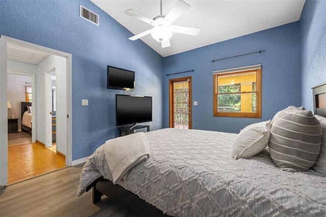 bedroom with vaulted ceiling, ceiling fan, and hardwood / wood-style floors