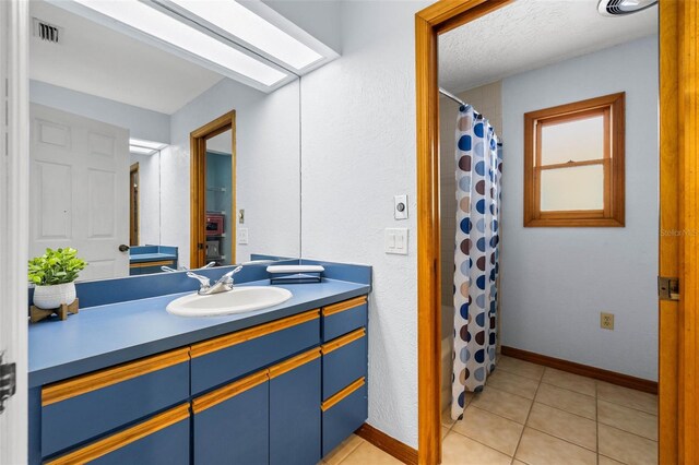 bathroom with vanity and tile flooring