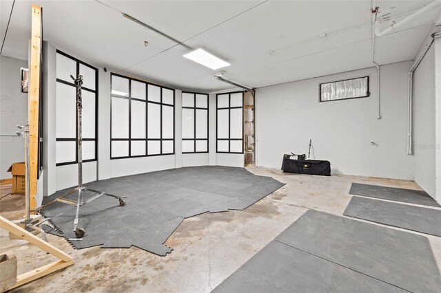 exercise area featuring concrete floors