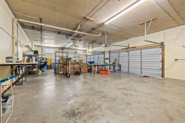 garage with a workshop area and a garage door opener