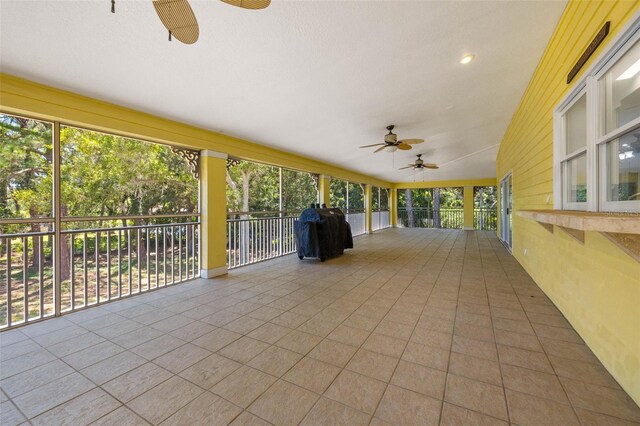 unfurnished sunroom with ceiling fan and a healthy amount of sunlight