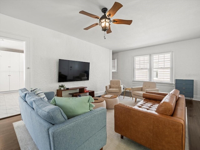 living room featuring ceiling fan and hardwood / wood-style flooring