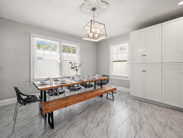 recreation room featuring light tile floors and a chandelier