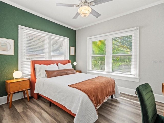 bedroom with wood-type flooring, ceiling fan, and crown molding