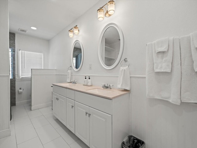 bathroom with double vanity and tile floors