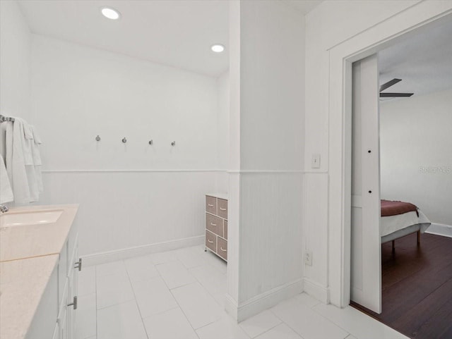 bathroom with ceiling fan, tile floors, and vanity