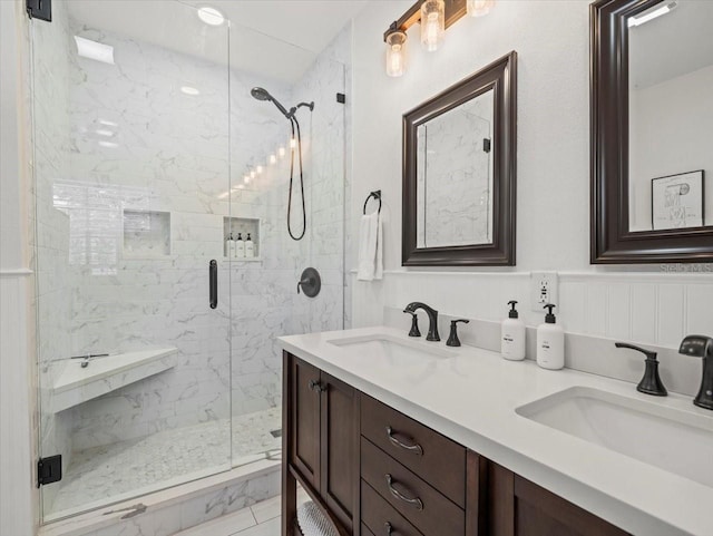 bathroom with walk in shower, dual vanity, and tile flooring