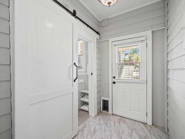 doorway featuring a barn door and light tile flooring