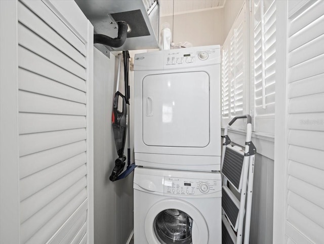 laundry area featuring stacked washer and dryer