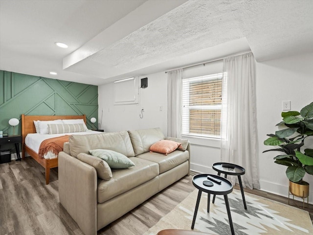 bedroom featuring hardwood / wood-style flooring and a textured ceiling