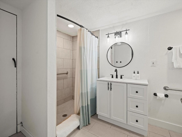 bathroom with walk in shower, tile floors, vanity, and a textured ceiling