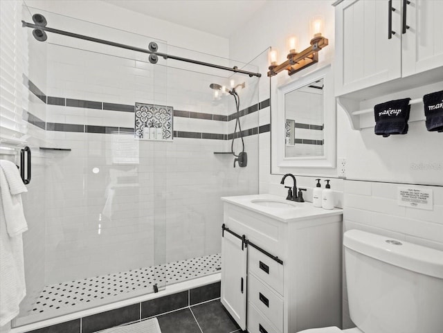 bathroom with an enclosed shower, tile walls, vanity, tile flooring, and toilet