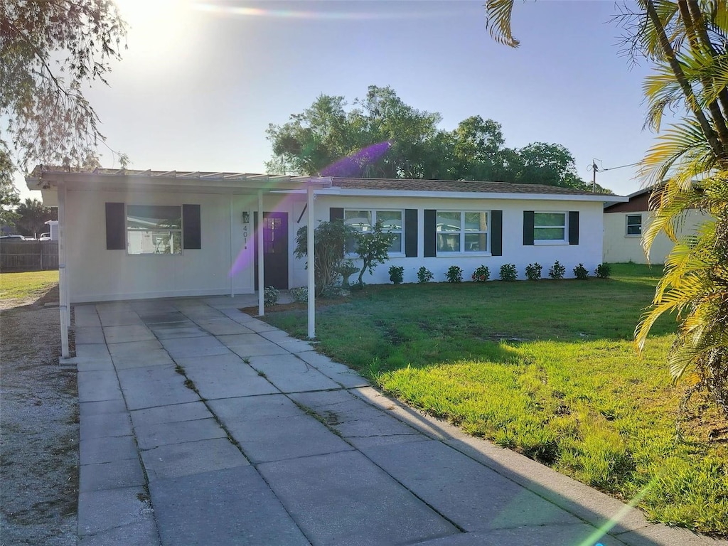 single story home featuring a carport and a front yard