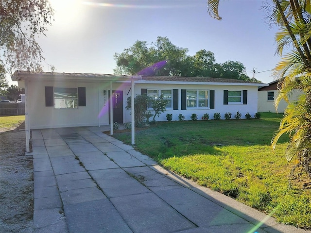 single story home featuring a carport and a front yard