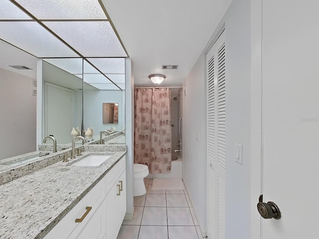 full bathroom with tile patterned flooring, shower / bath combination with curtain, vanity, and toilet