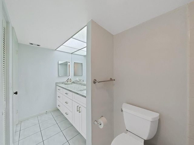 bathroom featuring tile patterned floors, vanity, and toilet