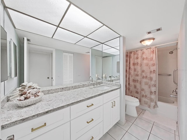 full bathroom featuring tile patterned floors, vanity, toilet, and shower / bath combo with shower curtain