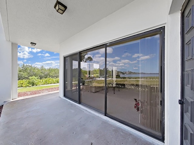 view of patio with a water view