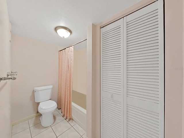 bathroom featuring toilet, tile patterned floors, and shower / bathtub combination with curtain