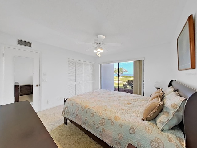 carpeted bedroom featuring access to outside, a closet, and ceiling fan