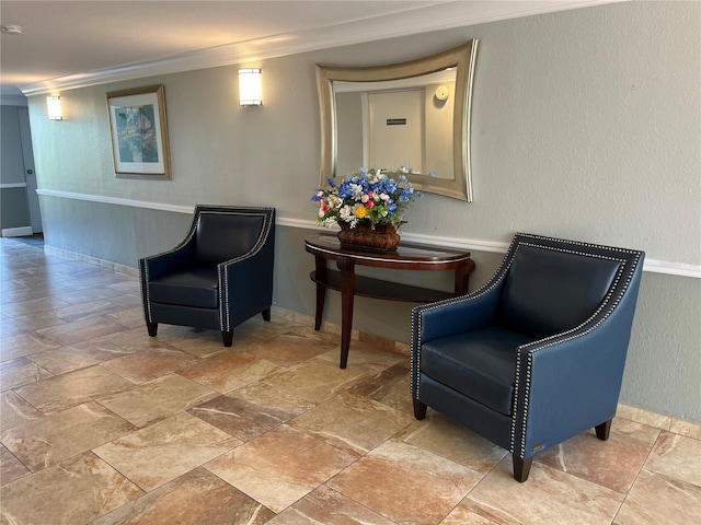 living area featuring ornamental molding