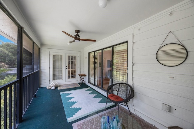 unfurnished sunroom featuring ceiling fan, french doors, and a wealth of natural light