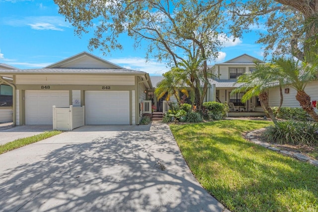 view of front of property featuring a garage and a front yard