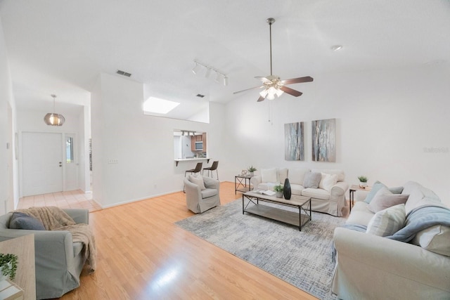 living room featuring visible vents, ceiling fan, wood finished floors, high vaulted ceiling, and baseboards