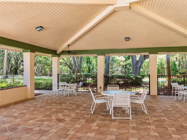 view of patio featuring fence, a ceiling fan, and outdoor dining space