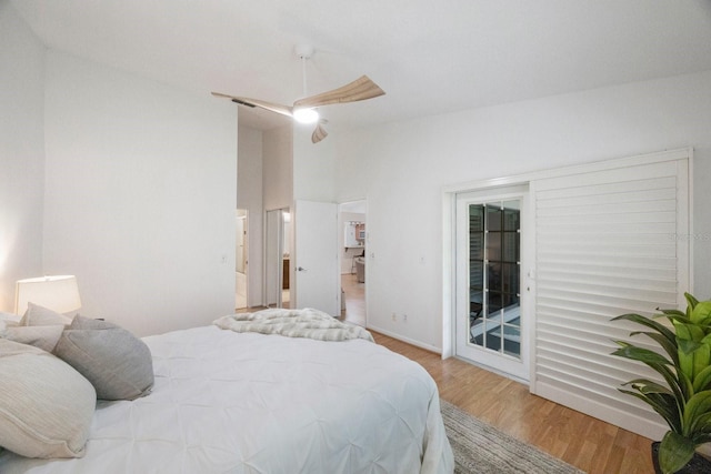 bedroom featuring light hardwood / wood-style floors, vaulted ceiling, ceiling fan, and access to exterior